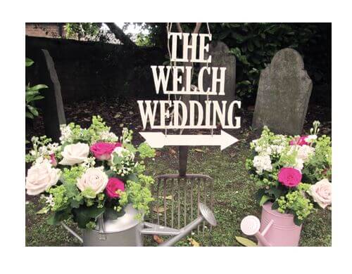 Watering can flower arrangement wedding venue decoration idea